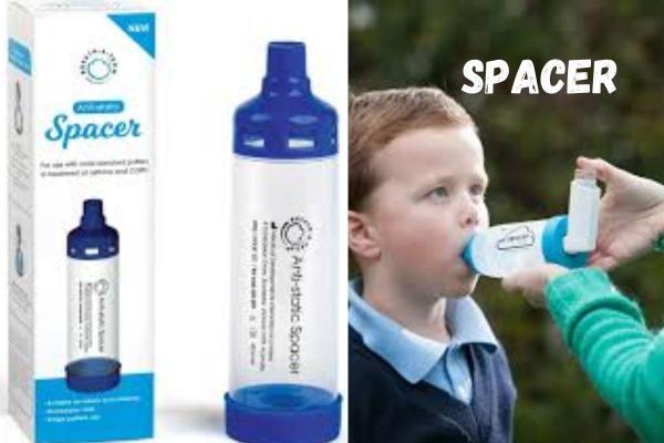 A clear anti-static spacer device with blue caps, shown in packaging and being used by a young boy with an inhaler.