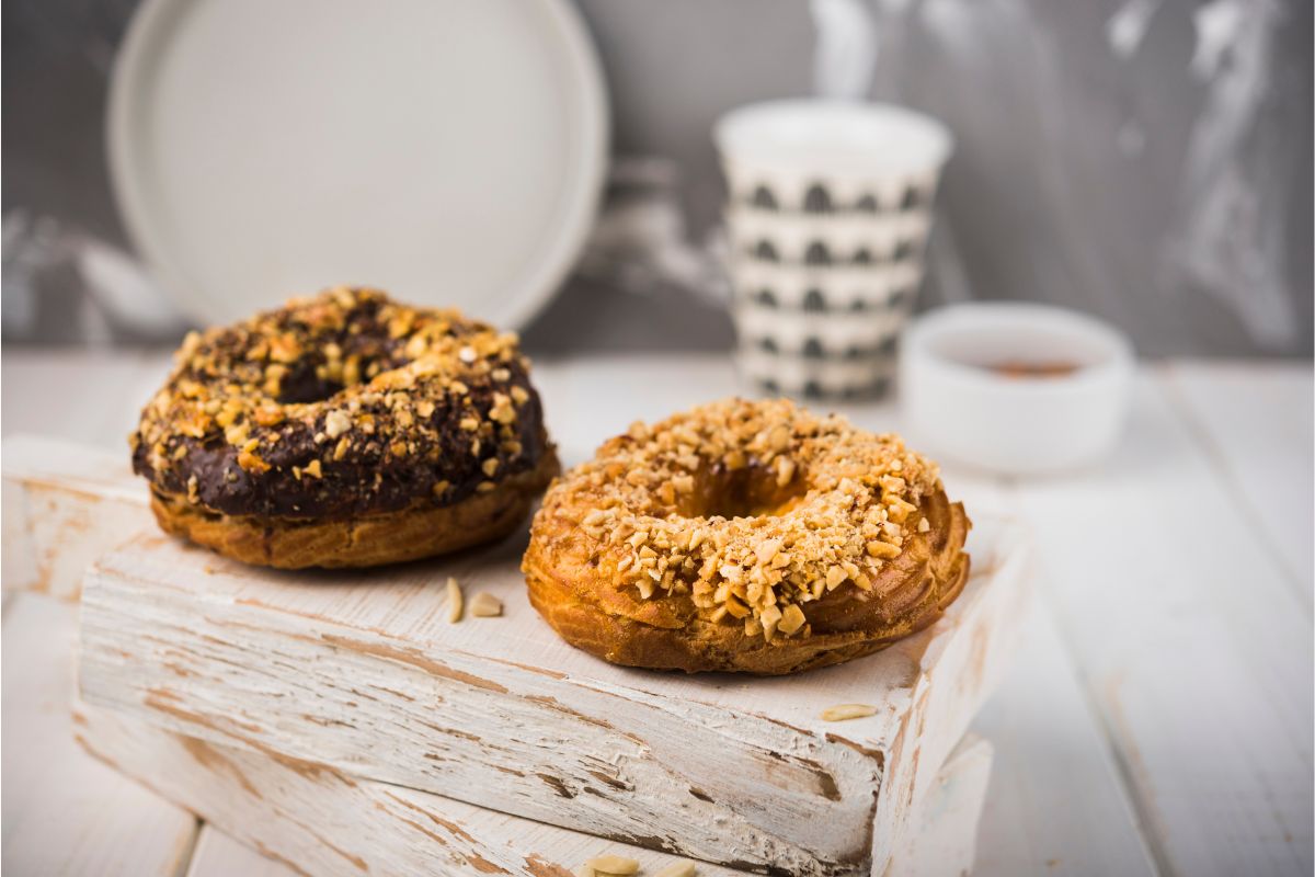 Everything Bagel with sesame seeds, poppy seeds, garlic, and onion flakes on a wooden board.